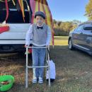 Robert Caldas, 7, leans on his walker in his old man costume. 