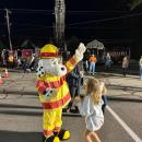 Kids high five the fire department's mascot. 