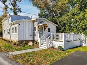 Front of 226 Sanford Road in North Westport, MA: a two-story home with board and batten siding and a front deck