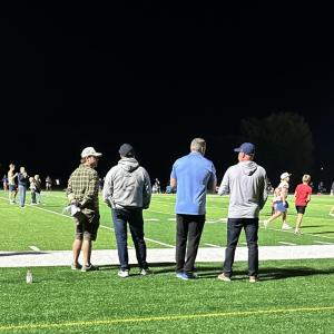 In this photo taken by Tabor sophomore Reya Hovan, Bill Belichick, second from the left, stands to watch the Tabor Academy football game. 