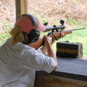 One woman aims her rifle at the 50 yard range. 