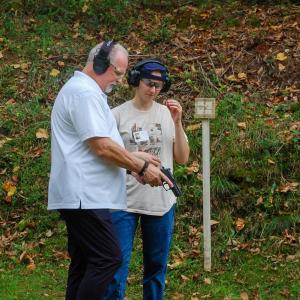 One coach teaches Autumn Tilley about a pistol. 