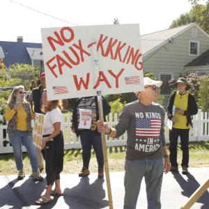 Ben Rogers of Mattapoisett holds up a homemade sign rejecting white supremacy in the United States.