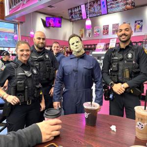 Officer Catilin White, Officer Emmanuel Matias, Sergeant Connor Ledin and Officer Amin Alkahal connect with the Rochester Community at Mary Lou's Coffee, alongside "Halloween" villain Michael Myers. Source: Rochester Police Department 