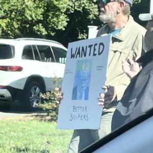 A protestor at the Mattapoisett "No Kings" rally holds a violent sign, leading to a police investigation. Source: Paul Criscuolo