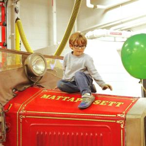 Vincent Bradley, 6, of Mattapoisett climbs on top of a vintage fire vehicle. Photos by Grace Ann Natanawan