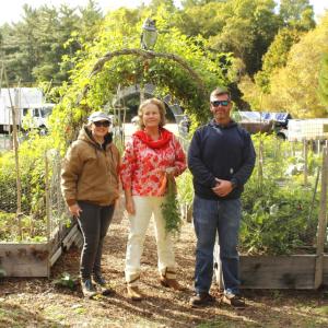 (left to right) Brooke Johnson, Barbie Burr and Mike Healey stand in front of the garden beds.