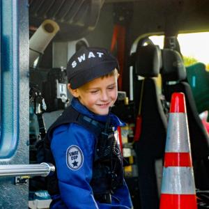 Beckham Sadler, age 5, sits in a fire truck dressed as a S.W.A.T. officer. Beckham Sadler, age 5, sits in a fire truck dressed as a S.W.A.T. officer.