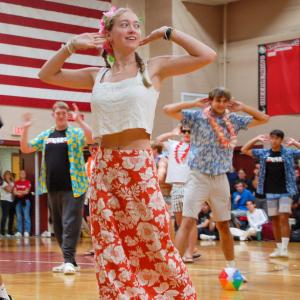 Seniors smile through their dance infront of the whole school and parent spectators.