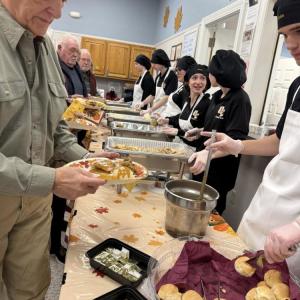 Students serve senior residents at the Rochester Council on Aging.