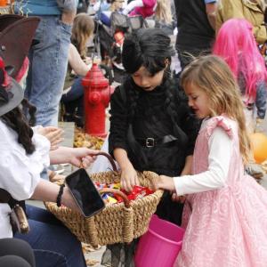 Emmy Philbrook, 5, of Marion stops to grab some candy along the Marion Art Center Halloween Parade route while dressed as a princess. Photos by Grace Ann Natanawan