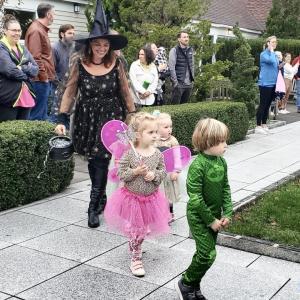 Preschoolers Lillie Sprayregen, dressed as a fairy, and Ambrose Bradley, dressed as "Gekko," march alongside Erin Braman who donned a witch costume.