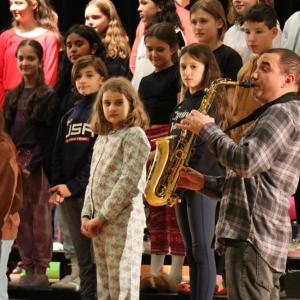 The Sippican School Choir rehearses with the Tri-County Symphonic Band in 2023. Photo by Sawyer Smook-Pollitt