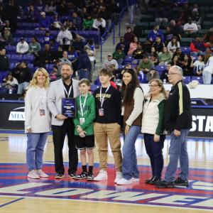 Matt Trahan poses with his family at the Tsongas Center in Lowell after being honored for receiving the Sherman A. Kinney Award in 2024. Photo by Liam Mayo