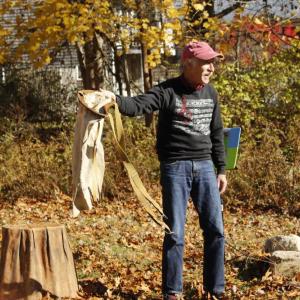 Gillman shows the audience how an apple picking sack functions.