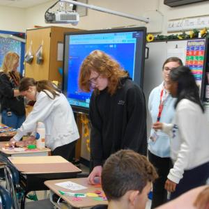 A high school student Henry Achilles helps out at the school he used to go to.
