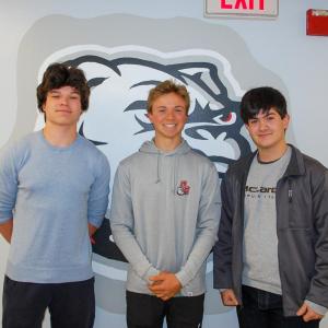 James Russell, Luke Pierre and Rafael Duarte, 3 class officers who created the cookbook, pose infront of an Old Rochester Bulldog. Photo by Mari Huglin