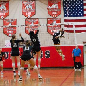 Molly Franco leaps to spike the ball. 