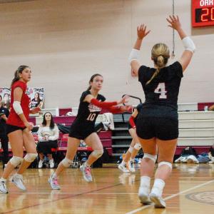 Molly Morrison sets the ball as Hadley King gets ready to jump and spike.