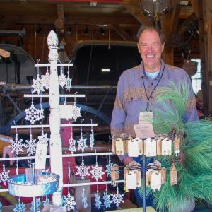A Red Oak Garden volunteer smiles in front of his table.