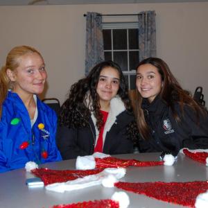 3 girls smile as they enjoy the festivities.