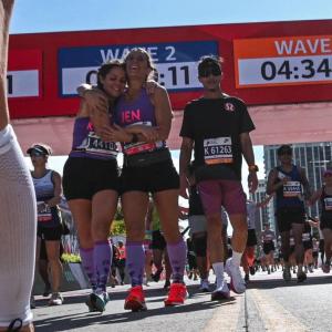 Pease crossing the Finish line of the Chicago Marathon in October of 2024 with her running partner, Kristen Wingate.