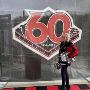 Elaine Botelho poses infront of a 60th anniversary poster. Source: Elaine Botelho