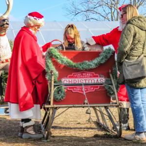 Grace Viglianti, center, and her mother Allie, right share a moment with the Clauses at Cervelli Farm Stand on Sunday, Dec. 7. Photos by Grace Roche