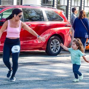 Kristie Simmons of Freetown reaches for her daughter’s hand at a Mother’s Day 5k on Sunday, May 11 in Mattapoisett. Photo by Abby Van Selous
