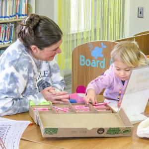 Jackie Steger, left, and Faye, 2, color together.