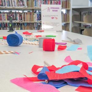 Streamer wands cover one of the tables in the library. 