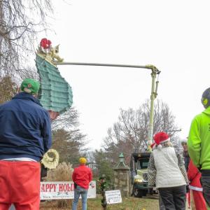 Community members look on as the hat is installed. 