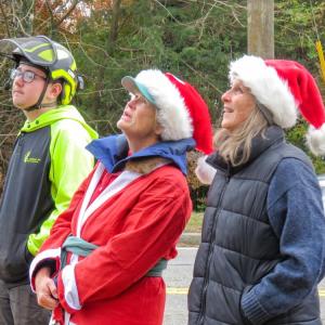 From left: Noah Knowles, Mary Dermody and Sarah French Storer watch the hat installation. 