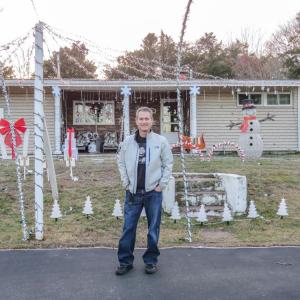 Carrier stands in front of his decorated home. Photo by Grace Roche