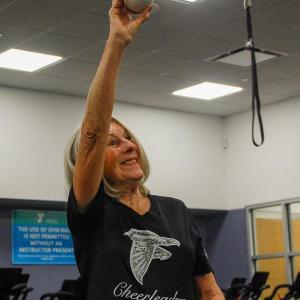 Elaine Botelho poses with a football she has had since 1966.