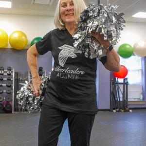 Botelho smiles with her pom poms.