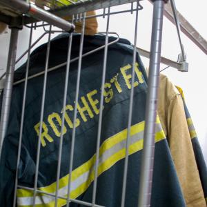Fire uniforms are hung in the garage.