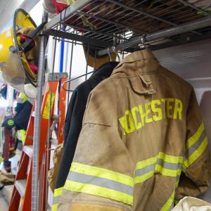 More fire uniforms hang in the fire station.