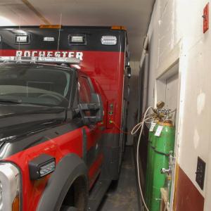 One fire truck is parked tightly in the garage.