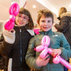 Aria Bell (left) and Margot Ketchel (right) show off their balloon animals at the annual YMCA tree lighting. Photos by Mari Huglin