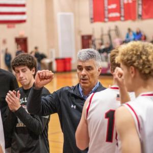 Steve Carvalho, middle, leads the Old Rochester Boys Basketball team in a pre-game speech before taking on West Bridgewater High School Friday, Feb. 14. Photo by Bobby Grady