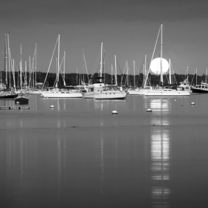 "Moonlit Sippican Harbor" showcases boats at rest in the water.