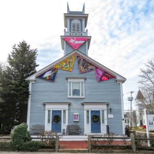 Colorful triangles of sailcloth adorn the outside of the Marion Art Center. 