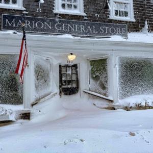 Strong gusts of wind blew snow onto buildings and covered windows, including at the Marion General Store. Photo source: Tucker Burr