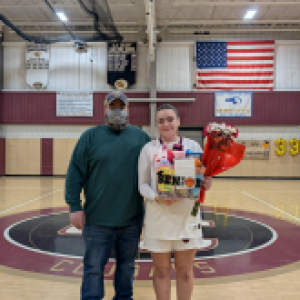 Sharon Delancey holds flowers and a gift basket she received  during the celebration. 