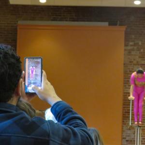 A member of the audience captures part of Liu's routine. 