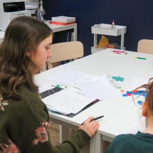 Penelope Angeley guides her student Olivia through a reading lesson. 