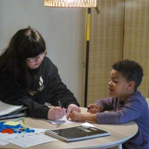 Sara Duane helps Emmerson with a worksheet during a peer tutoring session at the Learning Loft. Photos by Grace Roche