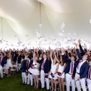 Graduates toss their commencement programs in the air at graduation on Friday, May 22. Photos source: Lawrence Films