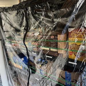Inside the truck, boxes of food ready for distribution line shelves. 